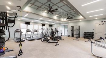 Premium fitness center with cardio equipment, free weights, and weight machines at The Retreat at Fairhope Village in Fairhope, AL